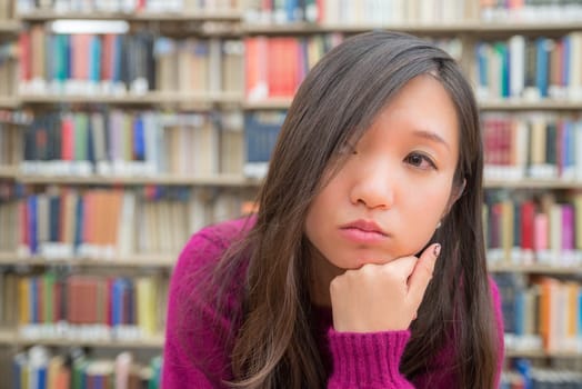 Close portrait of young woman in library