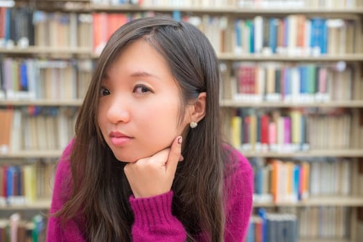 Close portrait of young woman in library
