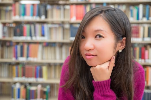 Close portrait of young woman in library