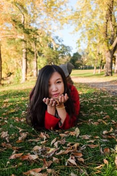 Woman laying on grass looking happy