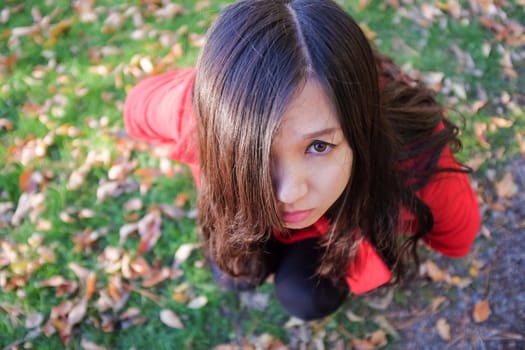Woman squating on the ground looking up