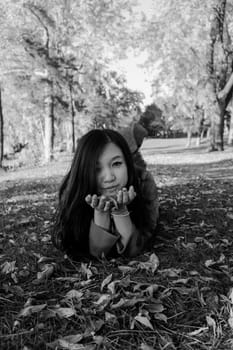 Woman laying on grass looking happy