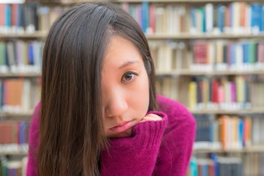 Close portrait of young woman in library