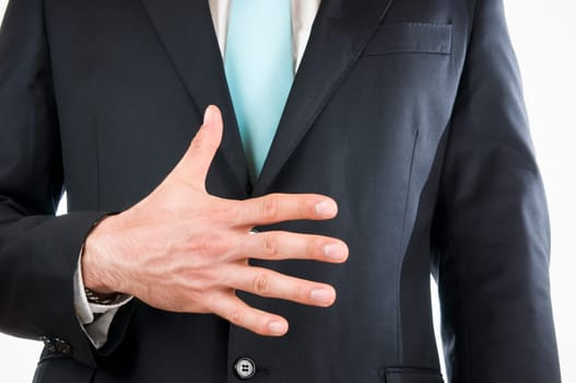 Chest-and-belly view of a young man in a black suit with his right hand held in front of him indicating the "5"" (five fingers)"
