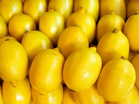 A pile of beautiful lemons on a counter