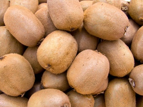 A pile of beautiful kiwis on a counter