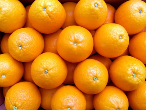 Agricultural background  a pile of beautiful oranges