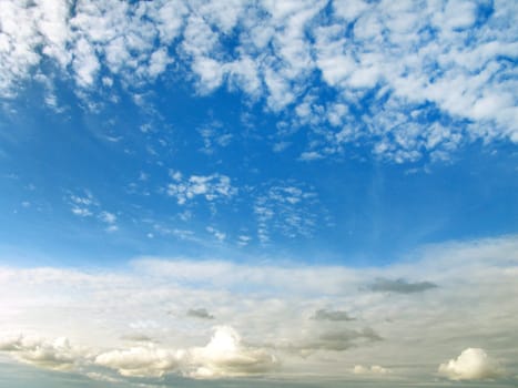 The blue sunny sky with beautiful white clouds