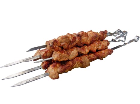 The shish kebab on skewers isolated on the white background