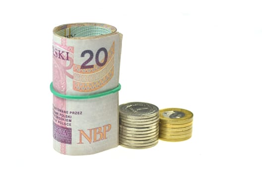 rolls of polish banknotes and coins isolated on white