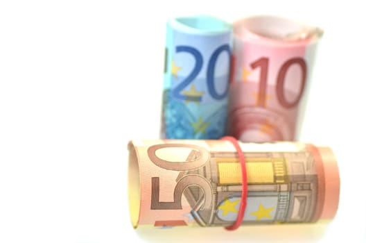 rolls of euro banknotes isolated on white