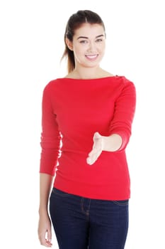 A beautiful young adult woman about to shake hands.