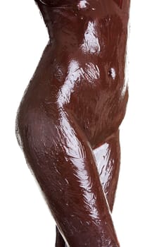 Naked female body covered with chocolate, isolated on white