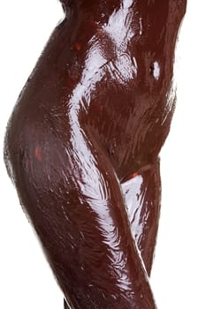 Naked female body covered with chocolate, isolated on white