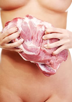 Nude woman holding big part of raw meat (pork neck). Protein diet concept.