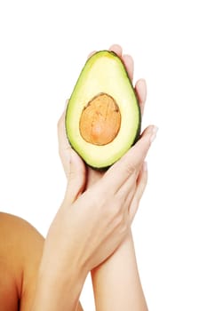 Pretty female hands holding fresh avocado, isolated on white