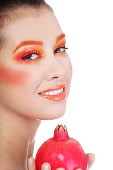 Portrait of young beautiful woman with pomegranates in her hands, on white background