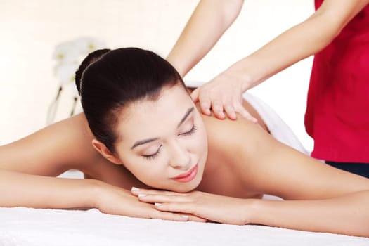 Preaty young woman relaxing beeing massaged in spa saloon