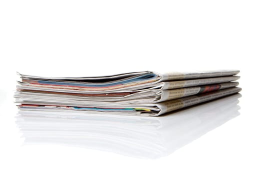 several newspapers stacked with white background