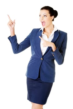 young female businesswoman pointing up. isolated on white.