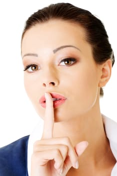 attractive business woman with finger on lips. portrait. isolated on white.
