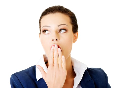 attractive businesswoman covers her mouth. isolated on white.