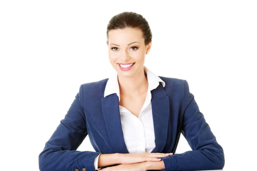 attractive business woman sitting and smiling. isolated on white.