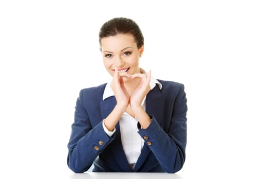 attractive business woman showing heart sign. isolated on white.