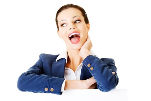 attractive business woman sitting laughing. isolated on white.