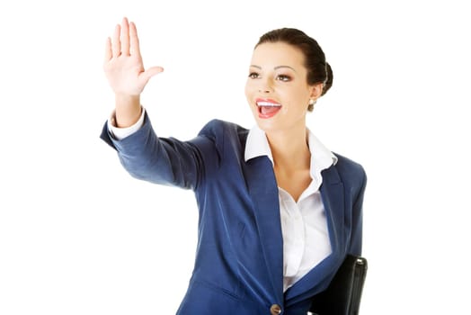 attractive business woman with hand up looking. isolated on white.