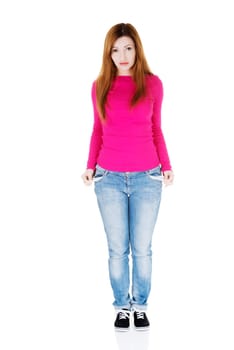beautiful woman standing and showing her empty pockets. isolated on white.