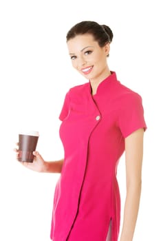 attractive woman in pink uniform holding a cup. isolated on white.
