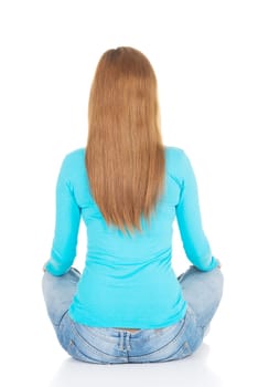attractive woman sitting. back view. isolated on white.