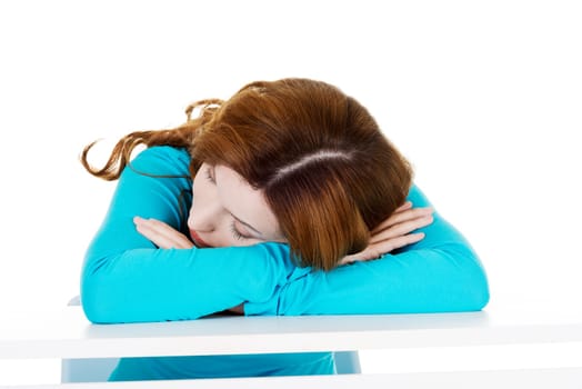 beautiful casual woman sleeping on a table. isolated on white.