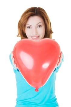 attractive woman giving a baloon heart. isolated on white.