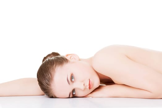 attractive woman lying on the floor and looking at camera. isolated on white.