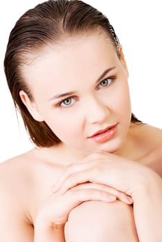 attractive young woman with wet hair. she's sitting. looking at camera. isolated on white.