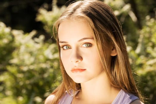 attractive woman outdoor looking at camera. sunny background.