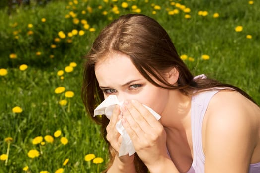 attractive young woman outdoor with tissue.