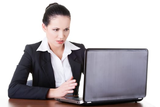 business woman sitting with a laptop. isolated on white.