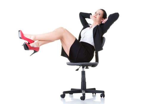 business woman sitting on a chair with legs up. isolated on white.