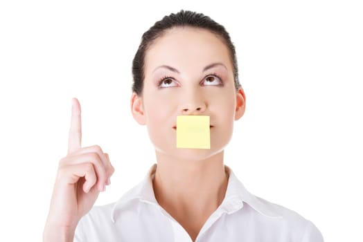 beautiful woman with empty card on lips,pointing up. isolated on white.