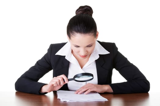business woman reading though magifying glass. isolated on white.