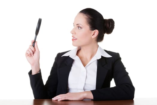 business woman looking through magnifying glass. isolated on white.