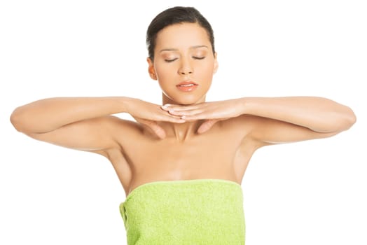 attractive woman wrapped in towel with hands under head. closed eyes. isolated on white.