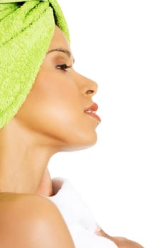 profile of attractive woman wrapped in towel with a turban. isolated on white.