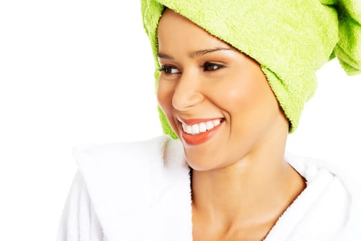 portrait of attractive smiling woman with towel wrapped in a turban. closeup. isolated on white.