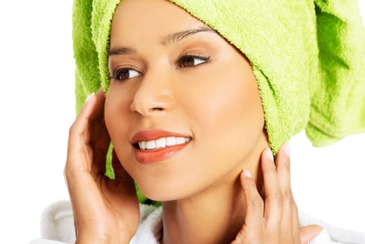portrait of attractive smiling woman wrapped in towel with turban. closeup. isolated on white.