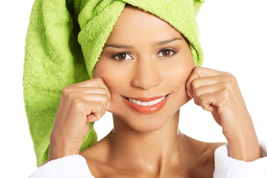 attractive woman wrapped in towel,holding her mouth in a smile. isolated on white.