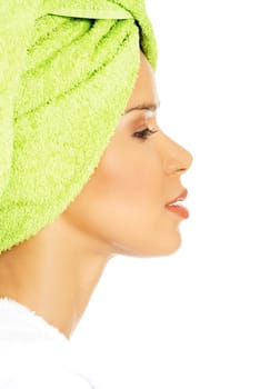 profile of attractive woman wrapped in towel with turban. isolated on white.